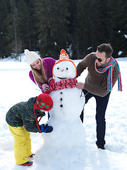 Image showing happy family making snowman