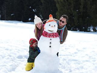 Image showing happy family making snowman