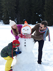 Image showing happy family making snowman