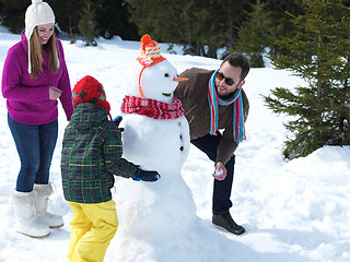 Image showing happy family making snowman