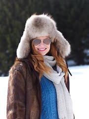 Image showing portrait of beautiful young redhair woman in snow scenery