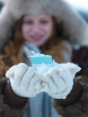 Image showing portrait of  girl with gift at winter scene and snow in backgron