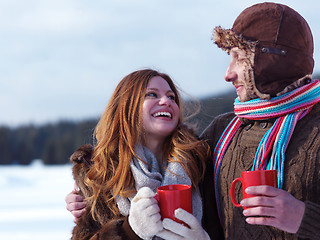 Image showing happy young couple drink warm tea at winter