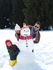 Image showing happy family making snowman