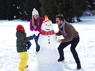 Image showing happy family making snowman