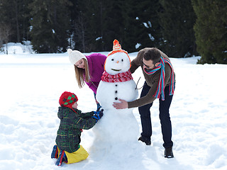 Image showing happy family making snowman