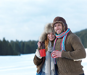 Image showing happy young couple drink warm tea at winter