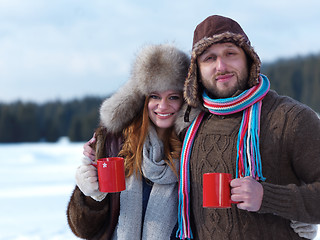 Image showing happy young couple drink warm tea at winter