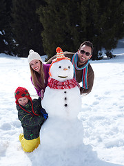 Image showing happy family making snowman