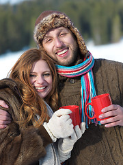 Image showing happy young couple drink warm tea at winter