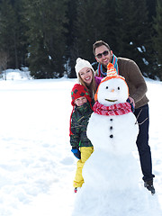 Image showing happy family making snowman