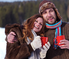 Image showing happy young couple drink warm tea at winter