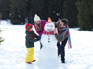 Image showing happy family making snowman