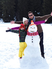 Image showing happy family making snowman