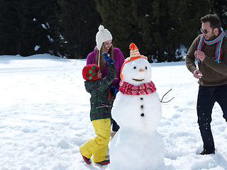 Image showing happy family making snowman