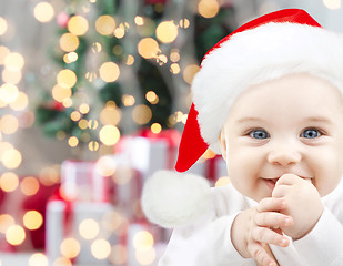 Image showing happy baby in santa hat over christmas lights