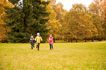 Image showing group of happy little kids running outdoors