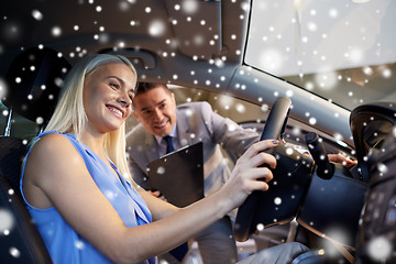 Image showing happy woman with car dealer in auto show or salon