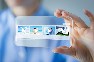 Image showing close up of woman with transparent smartphone