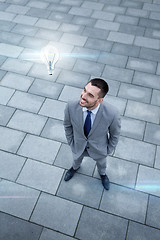 Image showing young smiling businessman outdoors from top