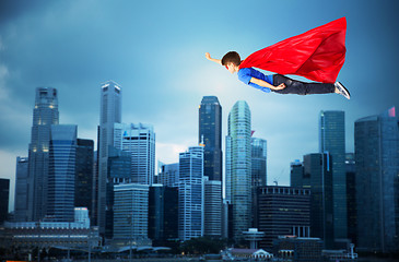 Image showing boy in red superhero cape and mask flying on air