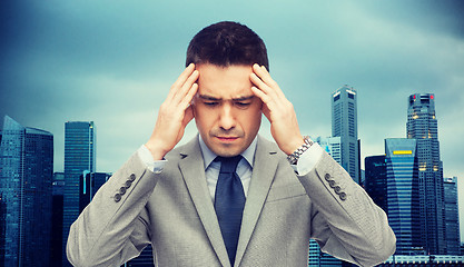 Image showing businessman in suit having head ache