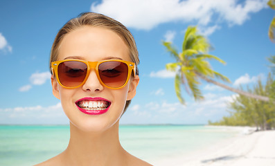 Image showing happy young woman in sunglasses with pink lipstick