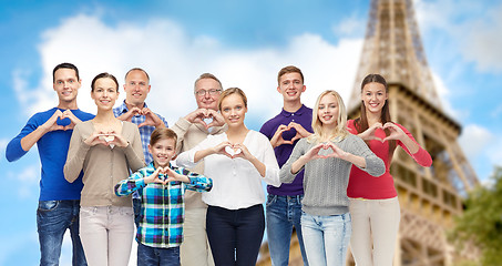 Image showing people showing heart hand sign over eiffel tower