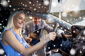 Image showing happy woman with car dealer in auto show or salon