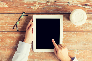 Image showing close up of female hands with tablet pc and coffee