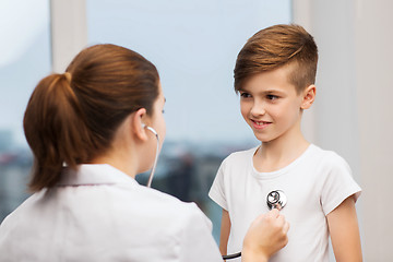 Image showing doctor with stethoscope listening to happy child