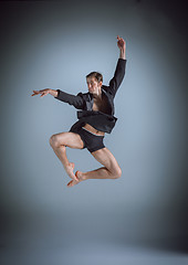 Image showing The young attractive modern ballet dancer jumping on gray background