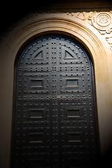 Image showing in london antique brown door  rusty  brass nail and light