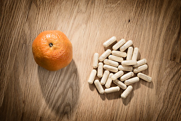 Image showing fruit and pills on table