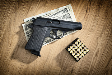 Image showing pistol with cartridges and dollar notes