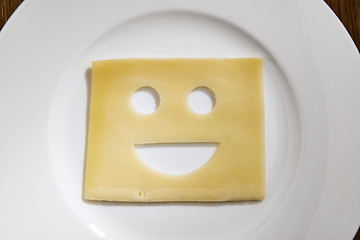 Image showing Cheese with smiling face on a table