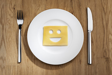 Image showing Cheese with smiling face on a table