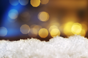 Image showing snow with lights in background