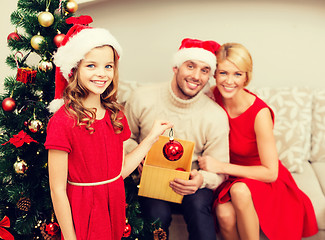 Image showing smiling family decorating christmas tree