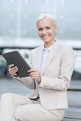 Image showing smiling businesswoman with tablet pc outdoors