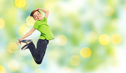 Image showing smiling boy jumping in air