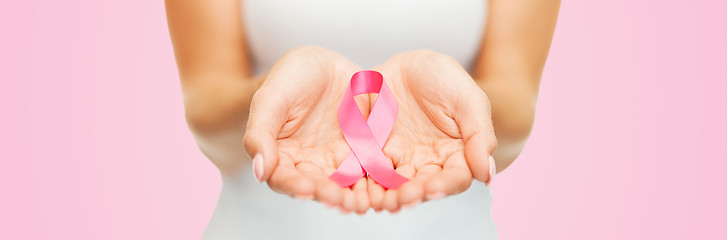 Image showing hands holding pink breast cancer awareness ribbon