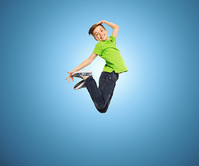 Image showing smiling boy jumping in air