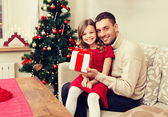 Image showing smiling father and daughter holding gift box