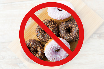 Image showing close up of glazed donuts pile behind no symbol