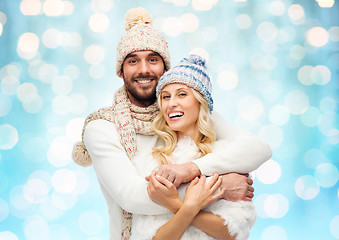 Image showing smiling couple in winter clothes hugging