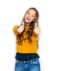 Image showing happy young woman or teen girl showing thumbs up