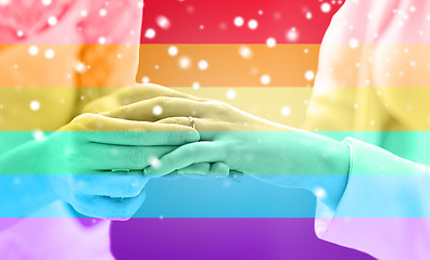 Image showing close up of lesbian couple hands with wedding ring