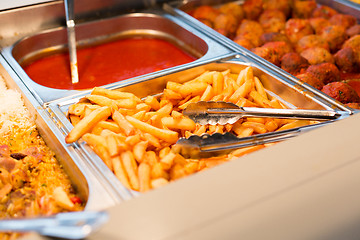 Image showing close up french fries of and other dishes on tray