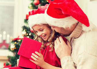 Image showing smiling father and daughter opening gift box